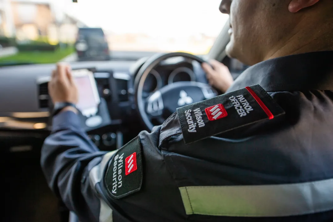 Wilson Security officer in uniform demonstrating the integrated services within Wilson Group's portfolio that relies on efficient cloud resource management.